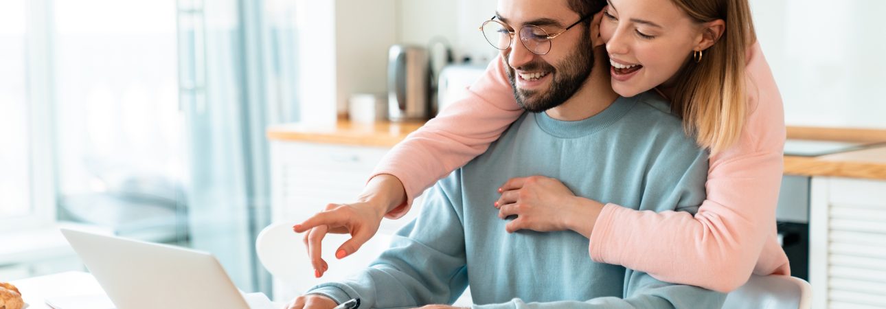 _happy_black_couple_moved_in_a_new_house_hugging_each_other_while_dancing_boxes_around_man_red_shir_ee3i2k1lekf451i8rurm_0